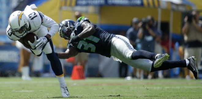 Kam Chancellor dives to try to tackle San Diego receiver Keenan Allen on Sept. 14 (AP)