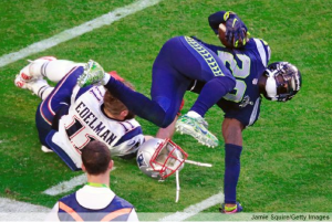 Jeremy Lane gets upended on an interception return in the first quarter, suffering a broken arm